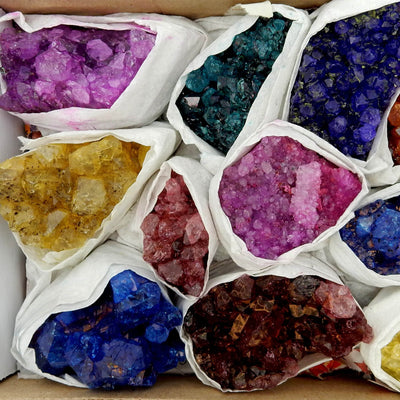 Dyed amethyst flat box with 11 pieces inside.  Quantity inside will vary.  Colors include pink, teal, blue, orange, red, and yellow.