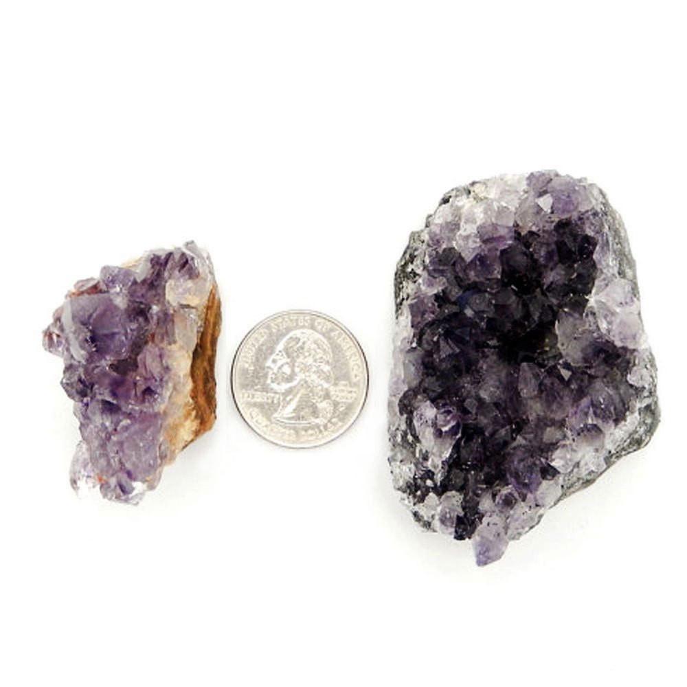 2 amethyst clusters next to a quarter
