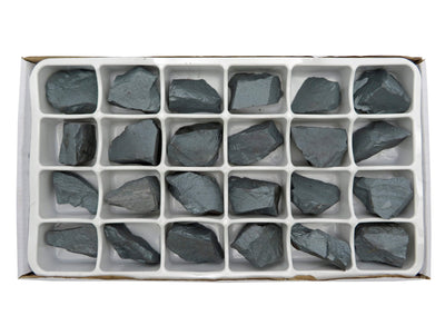 close up of varies chunks of hematite in white box slots to show different sizes and texture