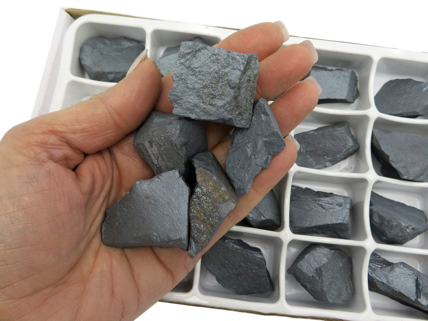 close up of varies chunks of hematite held in hand to show size and texture