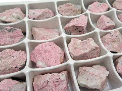Up close shot of Rhodonite Chunks in a box