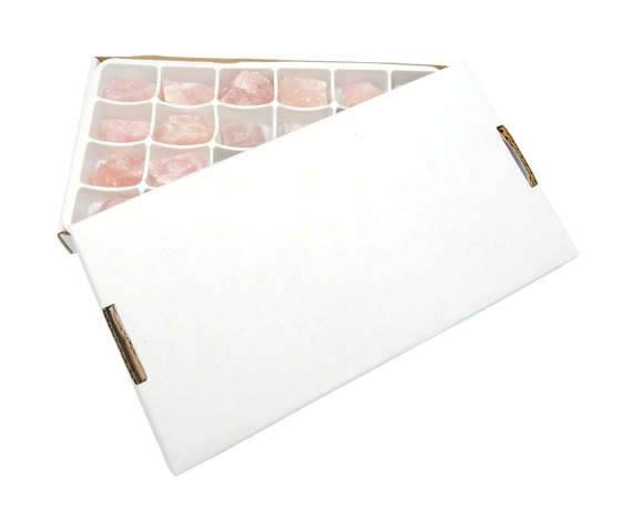 Box of rose quartz with lid on white background