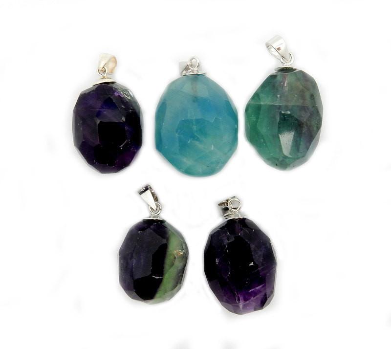 5 rainbow fluorite with silver toned bail displayed on white background to show various colors and sizes 