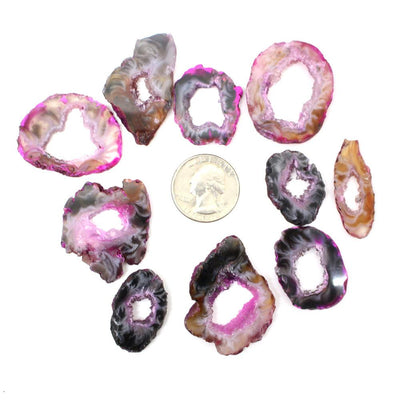 10 Dark Pink Geode Slice Around a Quarter Coin on White Background