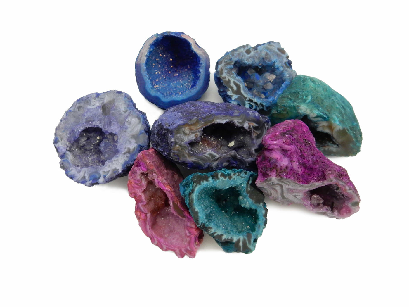 8 dyed geode halves in blue, teal, pink, and purple on white background