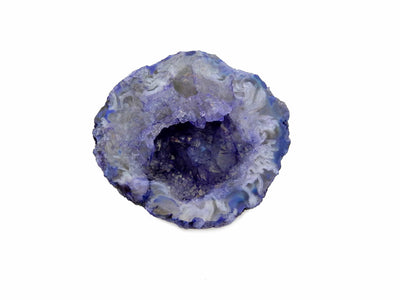 up close shot of dyed geode half in purple on white background