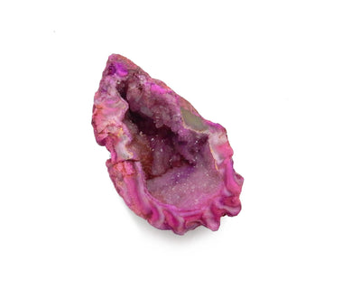 up close shot of pink dyed geode half on white background