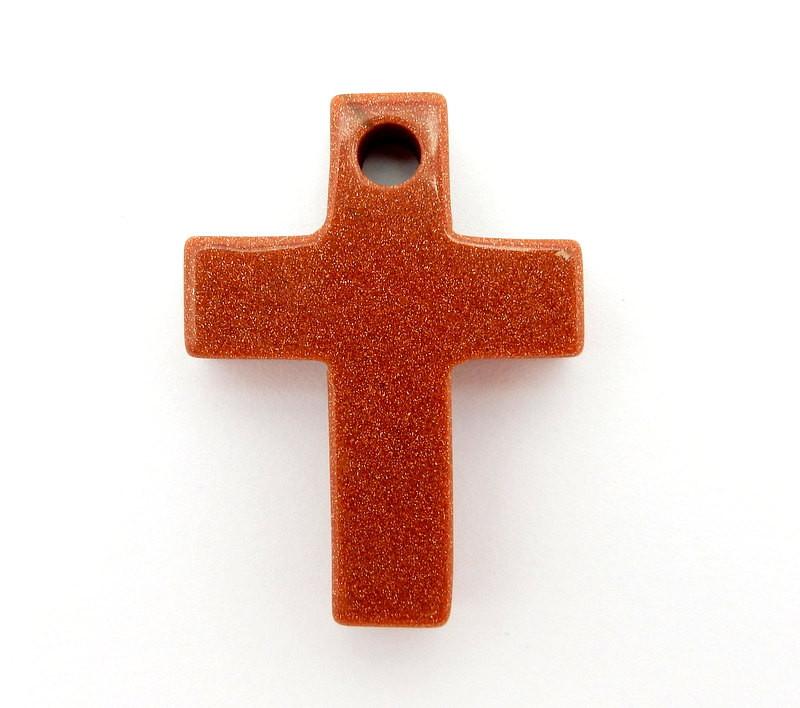 Goldstone red with sparkles cross on a white background.  It has a drilled hole on the top.