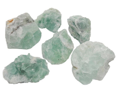 Six Green Fluorite crystals on a white background