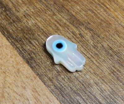 Single Petite Mother of Pearl Hamsa Hand with Eye Accent close up angle view