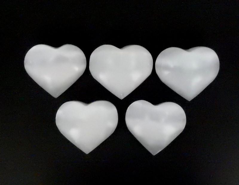 five selenite heart stones on display for possible variations