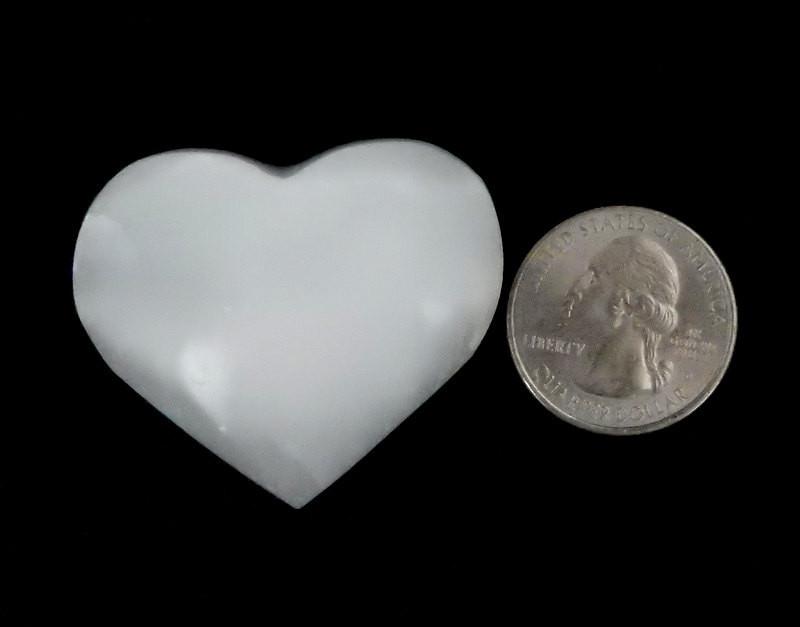 selenite heart stone with quarter for size reference