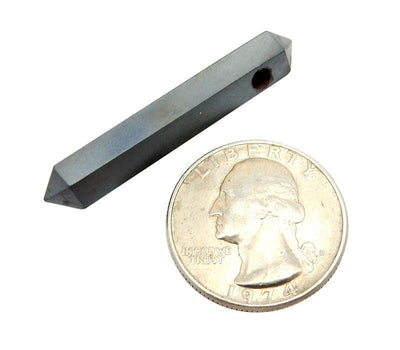 single head drilled hematite double terminated pencil point bead shown next to a quarter for size reference