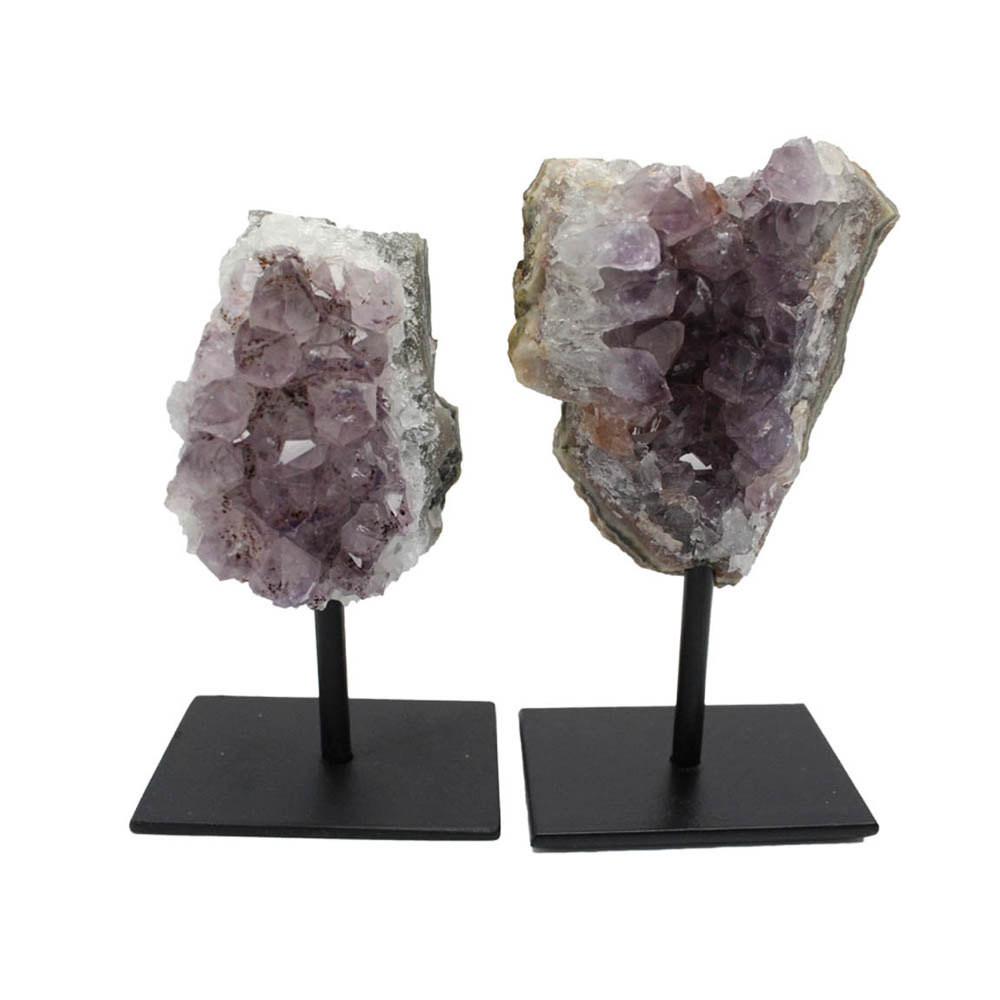 two One amethyst cluster on a black metal stand on a white background.