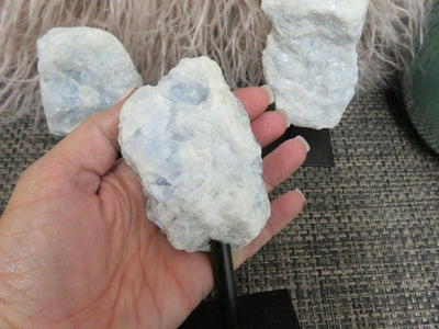 blue calcite on stand in a hand