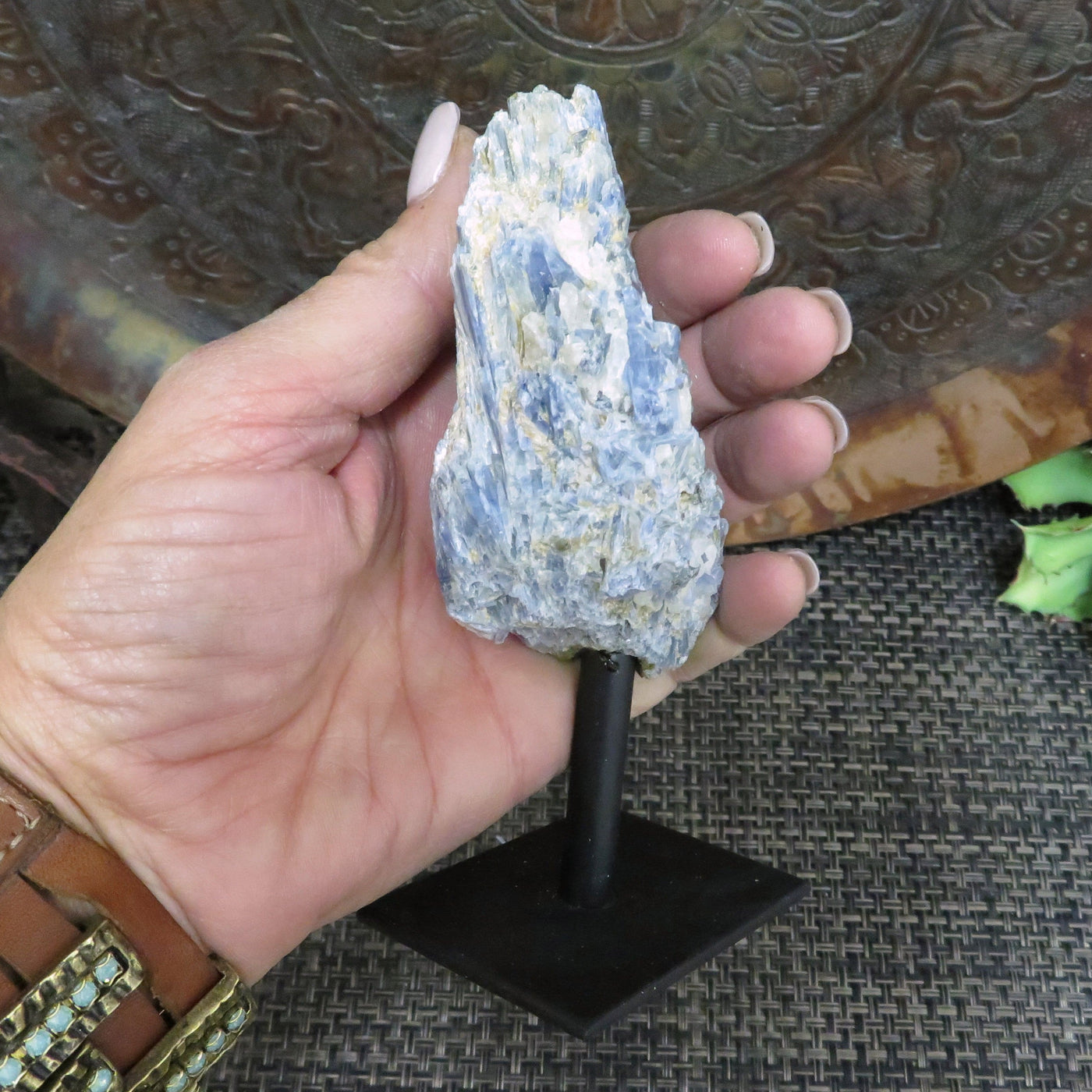 Blue Kyanite on Metal Stand in a hand for size reference