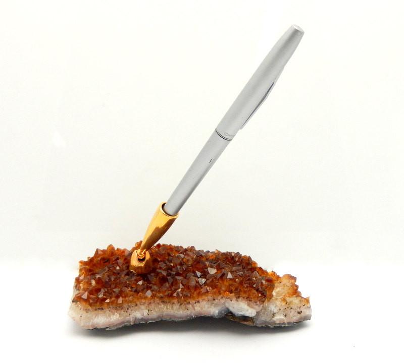 citrine cluster pen holder on a white background with a silver pen in it.