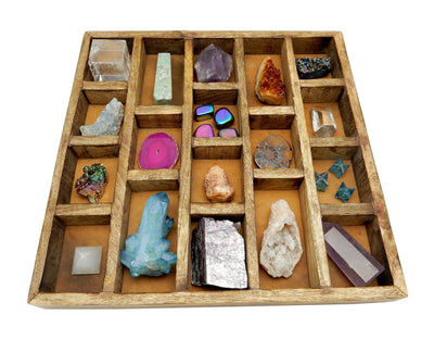 A Wooden Crystal Collector Display Organizer with many of our stones and crystals to show how it fits diffrent sizes 