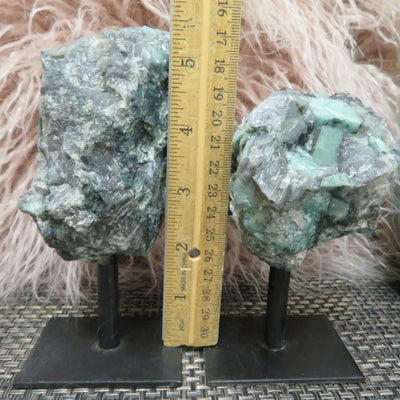 2 Emerald on Metal Stand with a ruler in the middle of each other showing  the different measurements