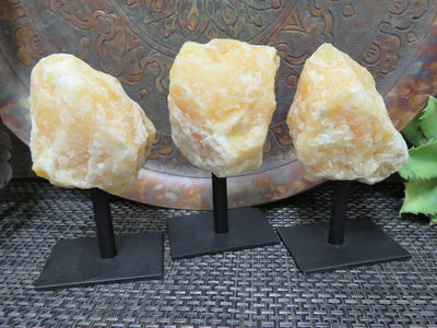 Products Orange Calcite on Metal Stand - 3 on a table