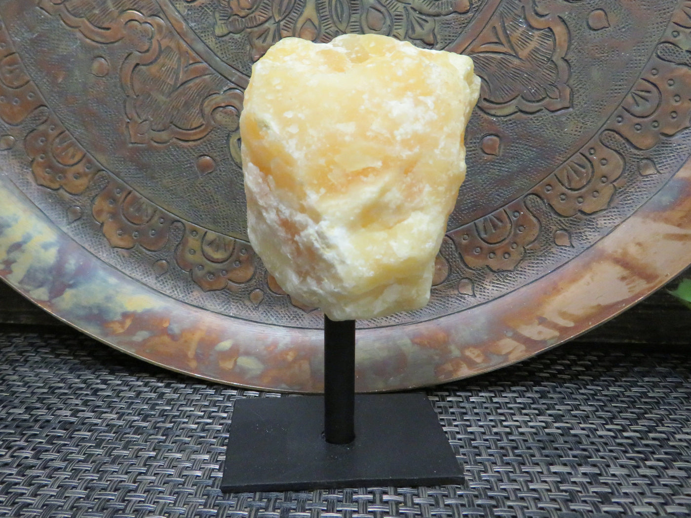 Products Orange Calcite on Metal Stand - close up of one