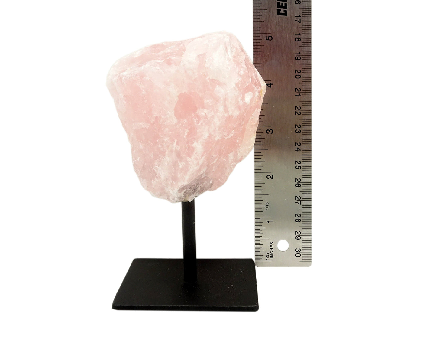 Rose Quartz on Metal Stand  next to a ruler for size reference on white background