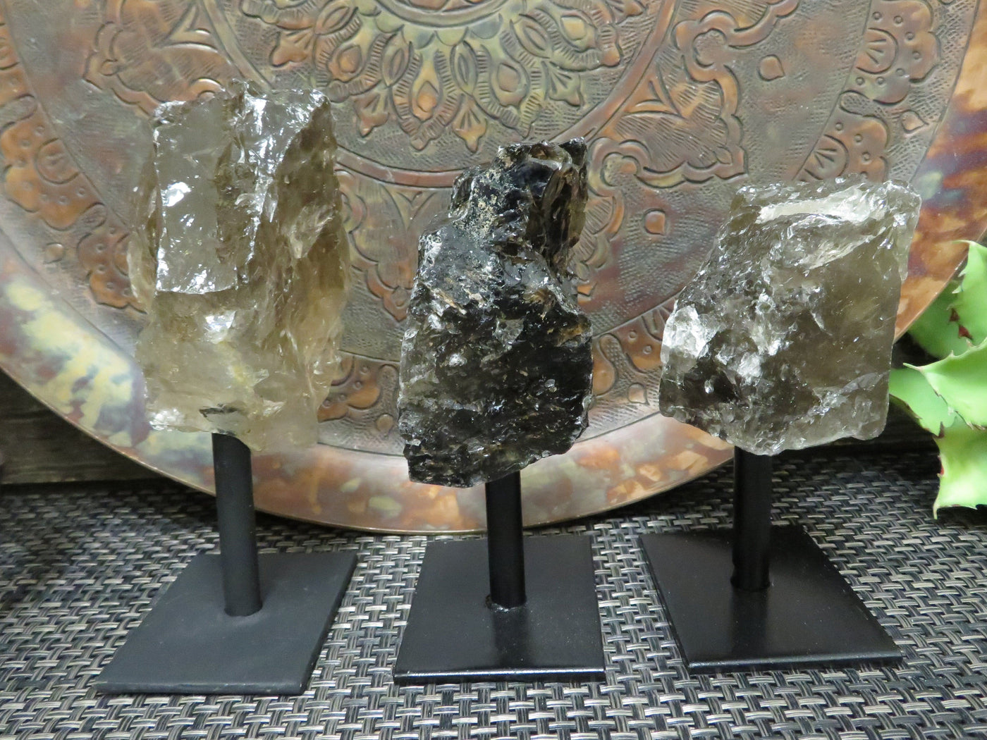 smoky quartz on metal stand with decorations in the background