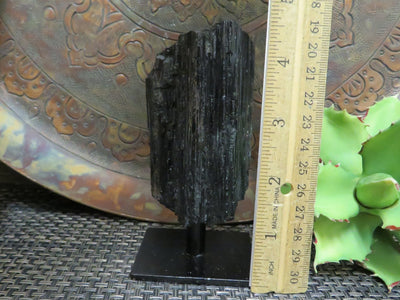 Tourmaline on Metal Stand next to a ruler for size