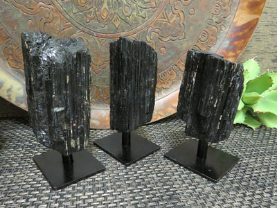 3 Tourmaline on Metal Stands on a table