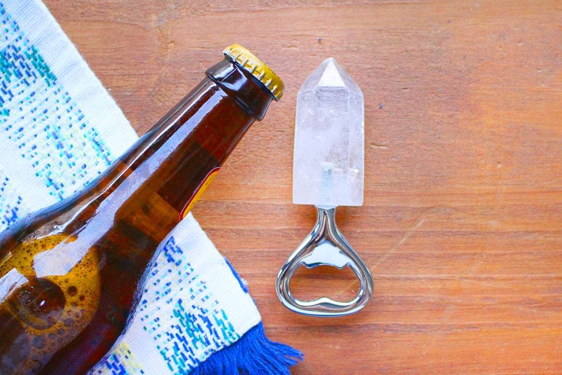 Natural Stone Bottle Opener - on a table next to a bottle