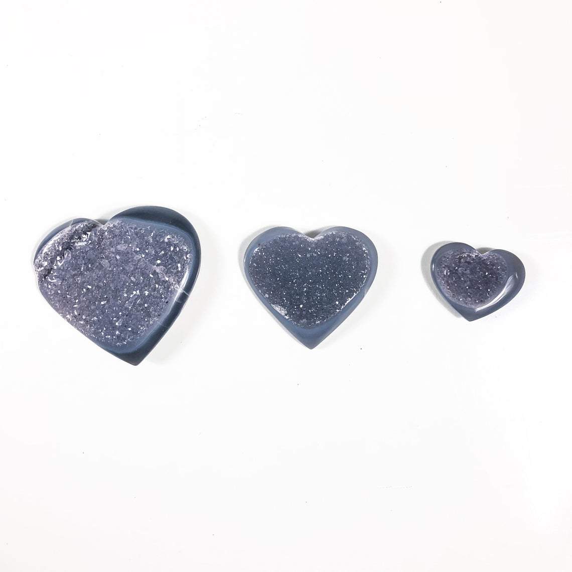 Three Agate Druzy Hearts shown to display weight comparision.