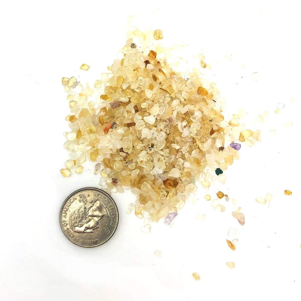 citrine chips next to a quarter for size reference 