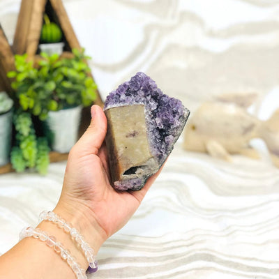 Amethyst Crystal Purple Geode With Calcite in hand, off of the stand