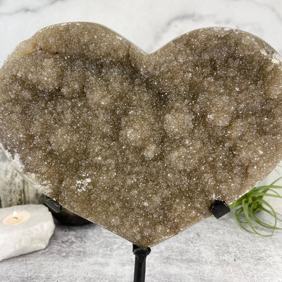 up close shot of Druzy Heart on Stand with decorations in the background