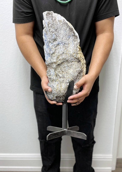 person holding up Products Blue Kyanite on Metal Stand