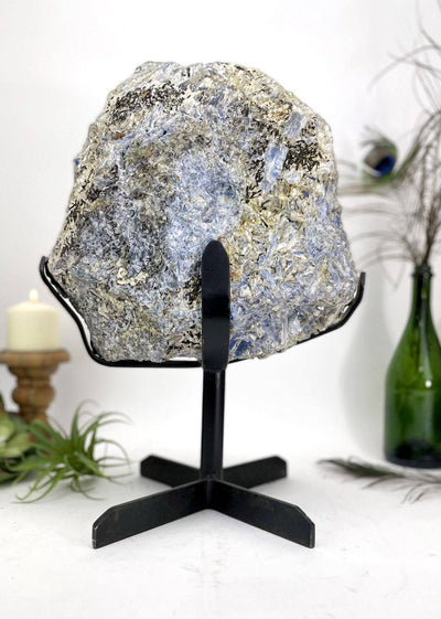 Large Blue Kyanite on Metal Stand with decorations in the background