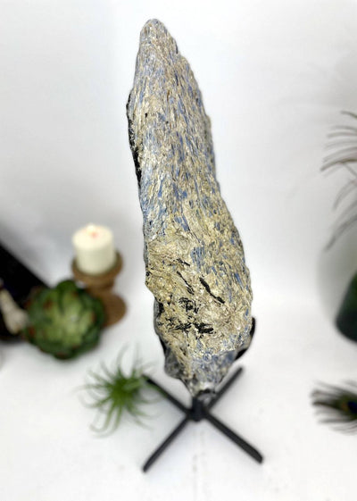 top view of Products Blue Kyanite on Metal Stand with decorations in the background