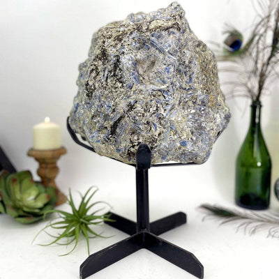 Large Blue Kyanite on Metal Stand with decorations in the background