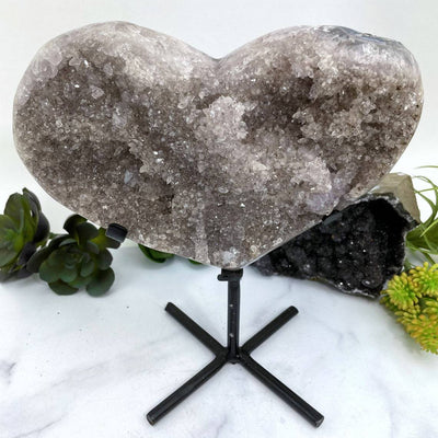 Amethyst Druzy Heart On Metal Stand with decorations in the background