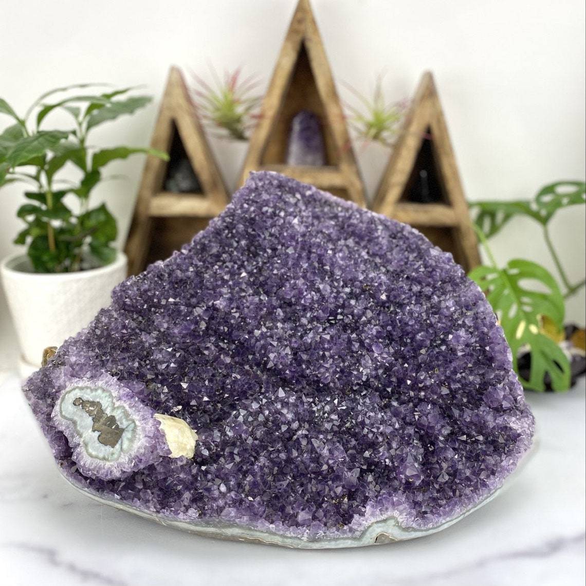 Amethyst Cluster with a Stalactite with Calcite with decorations in the background