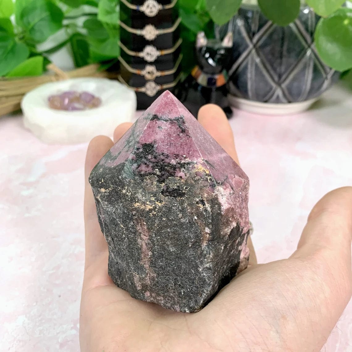 Rhodonite Semi-Polished Point - Cut Base in a hand for size reference