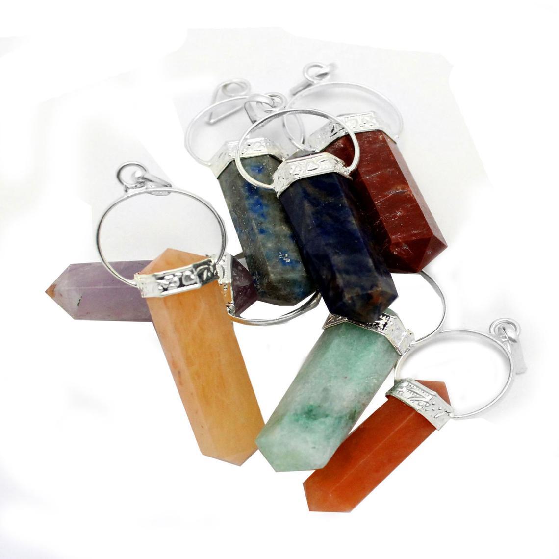 silver seven chakra point pendant set in a pile