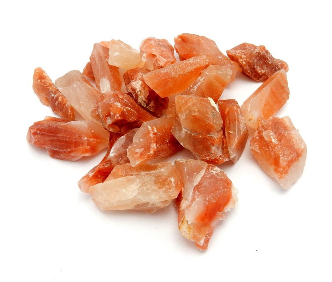 Pile of Red Calcite Stones on white background