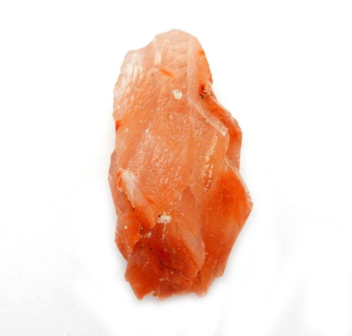 Up close shot of Red Calcite Stone on white background