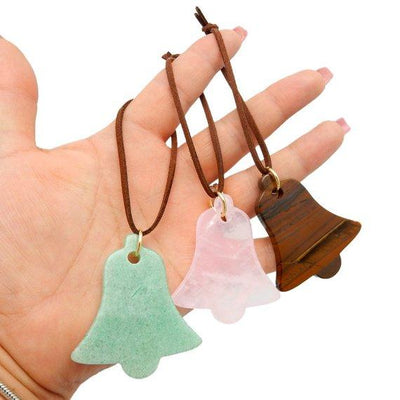 3 Bell Gemstone Christmas Ornaments placed in hand for different stone reference