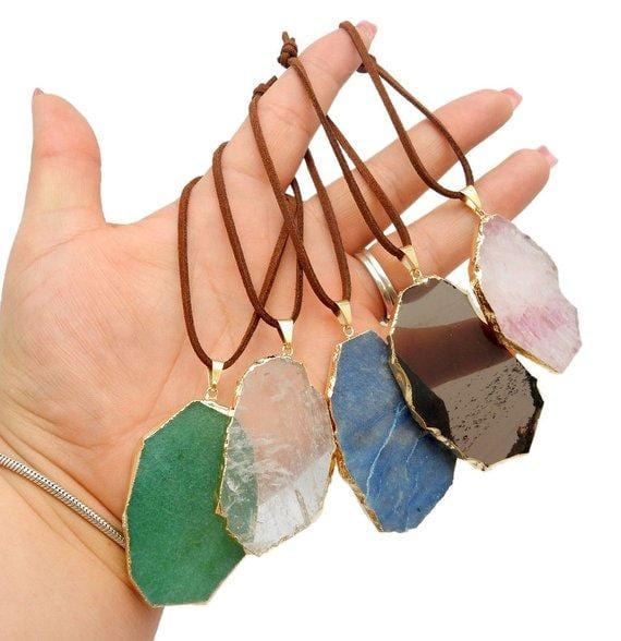 gemstone ornaments displayed in hand for size reference