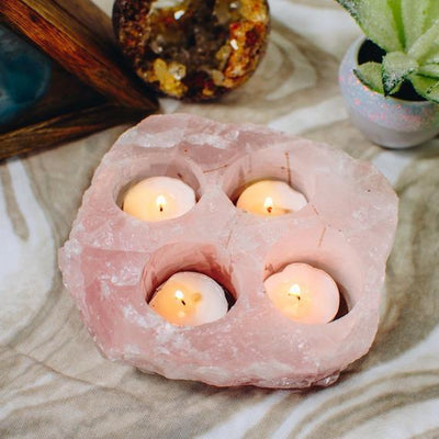 Rose Quartz Candle Holder with 4 candles inside with decorations in the background