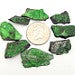 8 Uvarovite Stones around a quarter to show size 