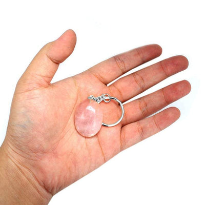 Hand holding up Rose Quartz Worrystone Keychain