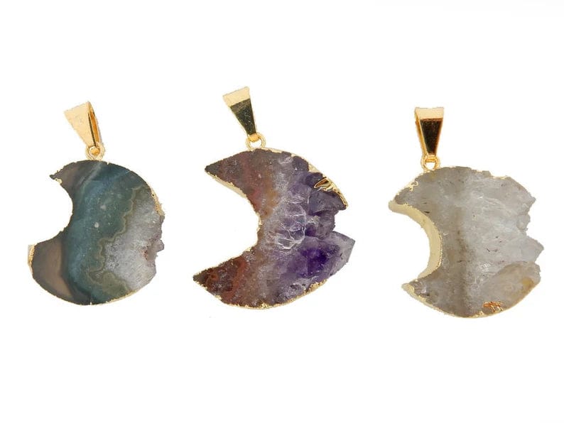 3 Amethyst slice moons with gold plating around the edges and a gold bail on a white background.